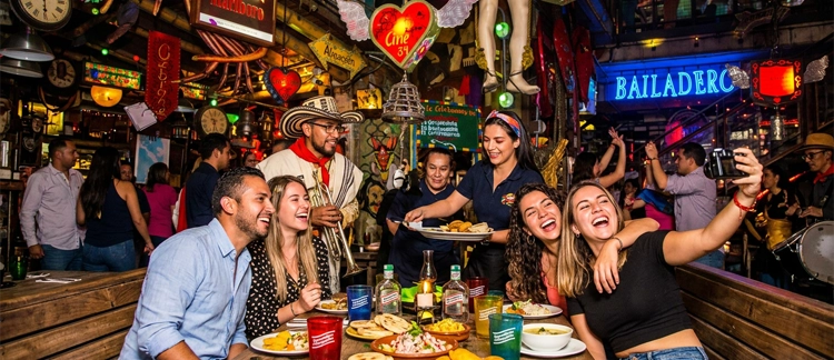 Group of friends celebrating with a vallenato musician