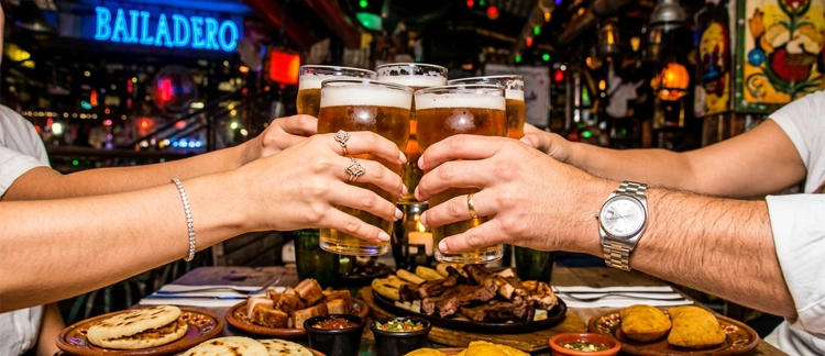 Beer toast among friends at Andrés Carne de Res