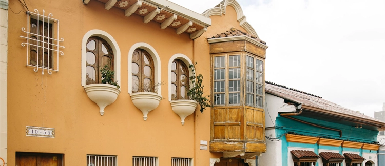 Yellow colonial façades with wooden balconies