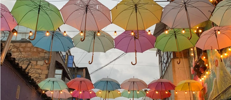 Colorful umbrellas hanging over a Candelaria alley