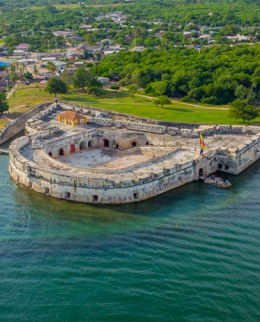 Aerial view of the colonial walls and San Fernando fortress in Cartagena, Colombia, surrounded by the Caribbean Sea.